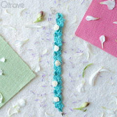 Hand Woven Blue Bracelet Studed With White Roses at Qtrove