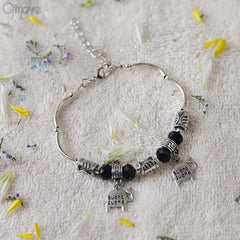 Handcrafted Charm Bracelet With Black and Silver Beads at Qtrove