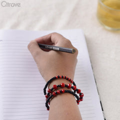 Set of Three Bracelets With Black And Red Beads at Qtrove