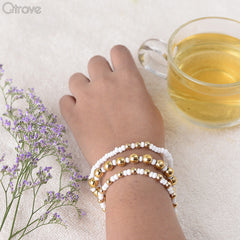 Set Of Three Bracelets With Golden And White Beads at Qtrove