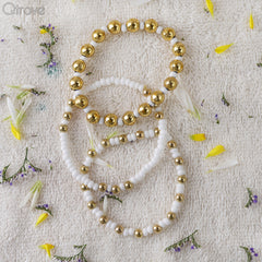 Set Of Three Bracelets With Golden And White Beads at Qtrove